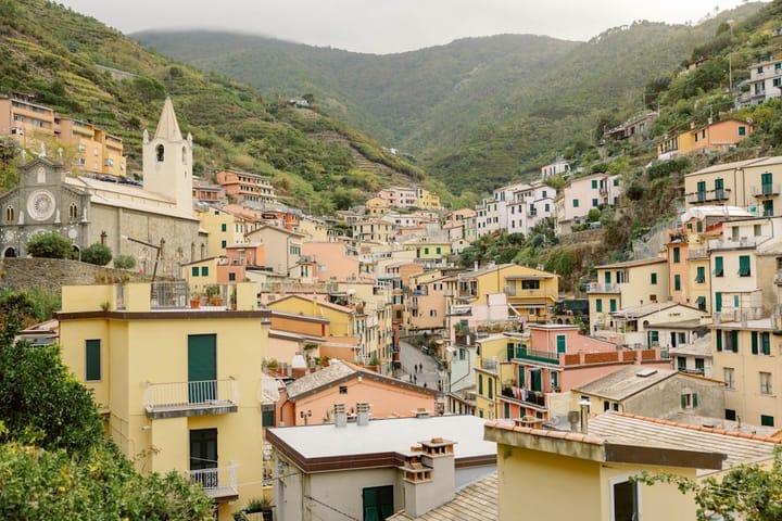 Charming coastal village in Southern Italy, showcasing colorful buildings, vibrant flowers, and a serene waterfront.