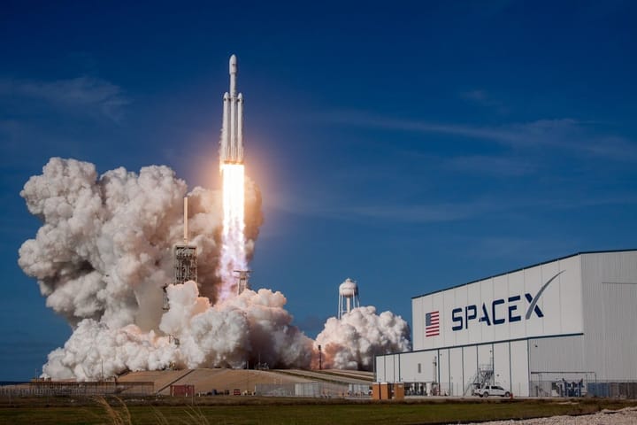 SpaceX and Cursor executives discuss AI strategies in a modern office setting, highlighting post-IPO investment trends.